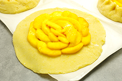 Placing Peaches on Dough