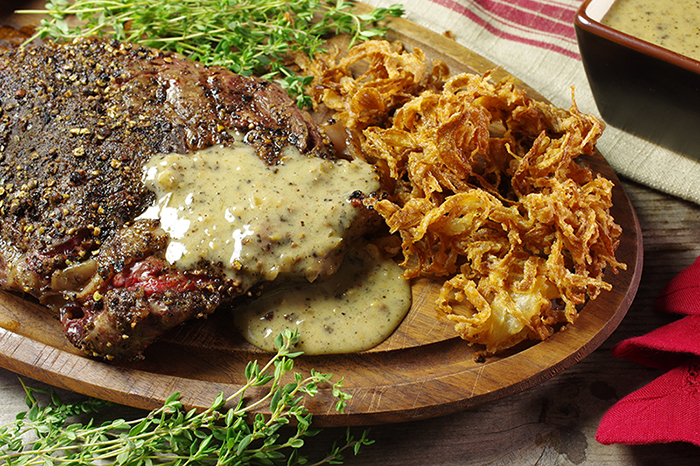 Grilled Rib-Eye Steak au Poivre with Onion Straws