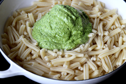 Add pesto to cooked pasta