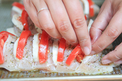 Place mozzarella and tomato slices inside the scored chicken